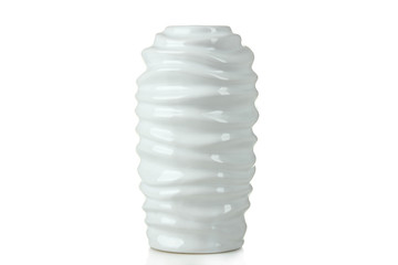
White fluted vase of flowers on a white background isolated.