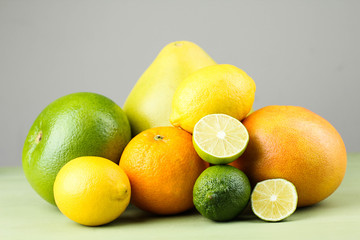 
A variety of fresh tropical fruit on green wooden background.