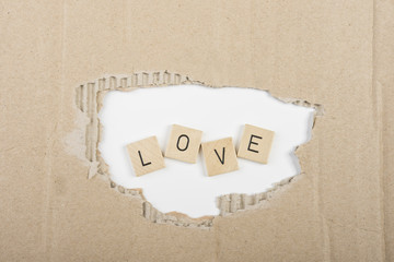 the word "love" through the hole in a carton