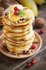 Pancakes with banana,walnut and caramel for a breakfast.