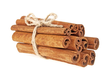 Cinnamon sticks tied with a natural rope, isolated on white back