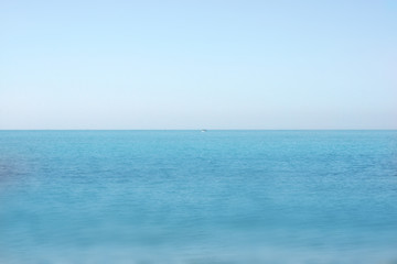 Obraz premium sea skyline blue background with a little boat