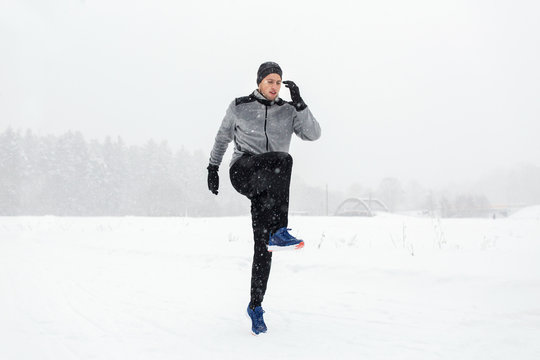 Man Exercising And Warmig Up In Winter Outdoors