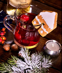 Still life of winter hot drink mulled and spruce branch. Warming mulled wine with cookie in form of house. Top view.