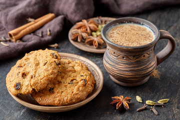Masala pulled tea chai latte traditional hot Indian sweet milk spiced drink, ginger, cinammon fresh spices blend, anise organic infusion healthy wellness beverage teatime ceremony in rustic clay cup