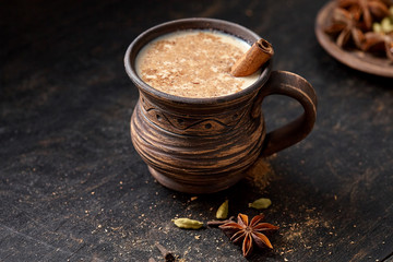 Milk tea chai latte traditional tasty refreshing morning breakfast organic healthy hot beverage drink with natural aroma spices blend, cardamon, anise, cinnamon, in rustic ceramic cup