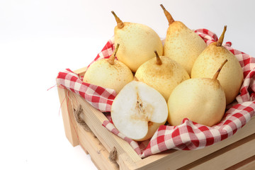Fresh chinese pears on wooden crate on white