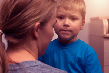 Mother and her little son hugging after quarrel