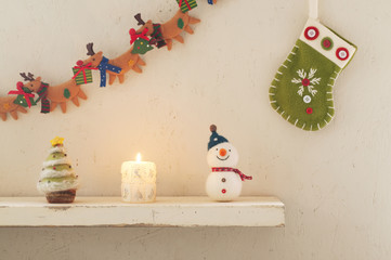 壁に飾り付けたクリスマスグッズとキャンドル