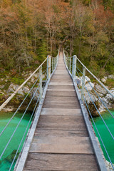 Wooden bridge the turquoise green Soca river in Slovenia