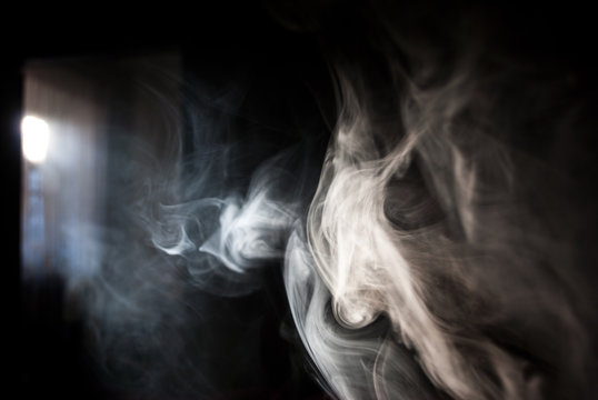 Fluffy Puffs of Smoke and Fog on Black Background