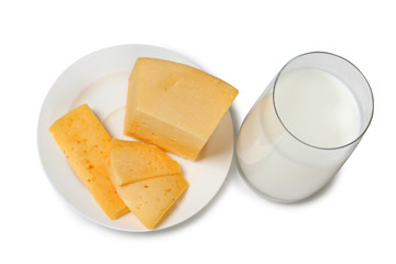 Cheese with milk in glass on white background