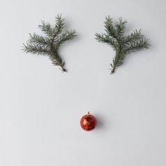 Reindeer face made of Christmas decoration and pine branches. Mi