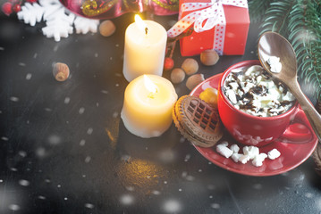 Fototapeta na wymiar cup of cocoa with marshmallows and Christmas gifts in the backgr