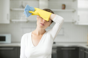 Tired and exhausted woman, frustrated with doing much work about the house resting for a minute or...