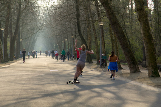 A girl on a scateboard in the Vondelpark in Amsterdam