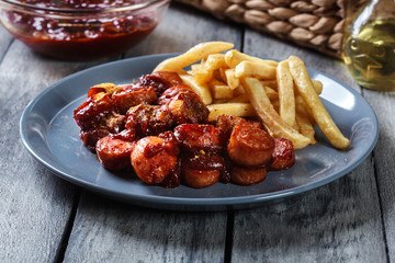 Traditional German currywurst - pieces of sausage with curry sauce
