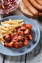 Traditional German currywurst - pieces of sausage with curry sauce