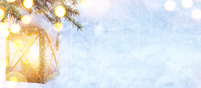 Snow Christmas tree and Holidays light on blue winter background