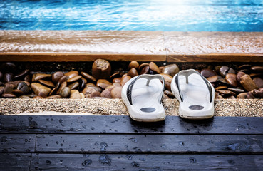flip-flops by the swimming pool