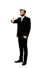 Engineer in protective helmet with thumbs up.