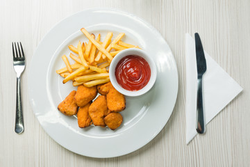 Chicken nuggets with french fries and ketchup
