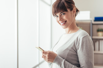 Cheerful attractive woman using a mobile phone