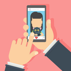 Girl with cat on the screen. Hand holding smartphone with photo of the girl. Concept of applications or social networks. Like button.