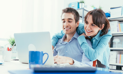 Young couple surfing the web at home
