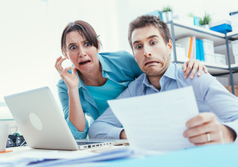 Stressed couple checking bills