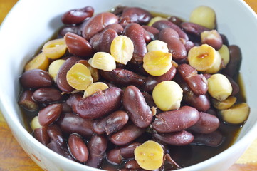 boiled hot lotus seed and red bean in syrup on bowl