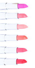 Border of puple, pink and red shades of open lipsticks isolated on white background