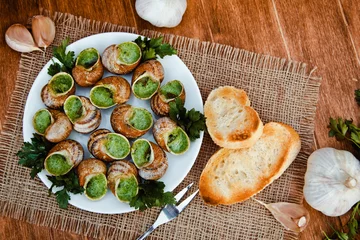Photo sur Aluminium Plats de repas Escargots de Bourgogne - Snails with herbs butter, gourmet dish in French traditional  with parsley and bread on white platter