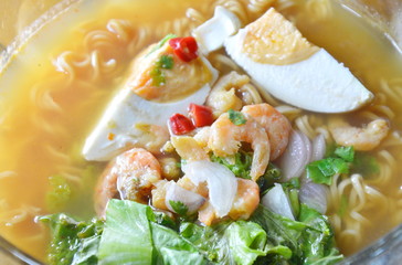 spicy boiled instant noodle topping salty egg and dried shrimp on bowl