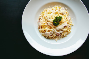 Classic Pasta carbonara Italian with Parmesan Cheese on black background