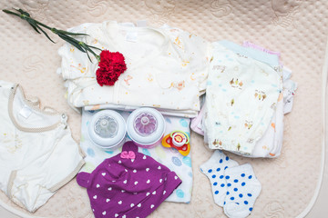 newborn baby clothes with bottle of milk for infant