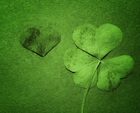 Petal of clover on green paper, close up. St. Patricks Day green shamrock . Vintage effect. - Powered by Adobe