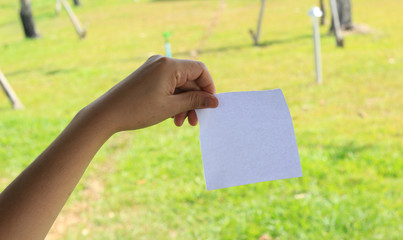 close up of a hand holding blank note paper