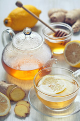 ginger tea with honey and lemon on wooden table
