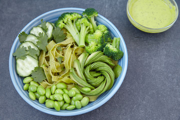 Vegetarian pasta with cucumber, broccoli, avocado and edamame