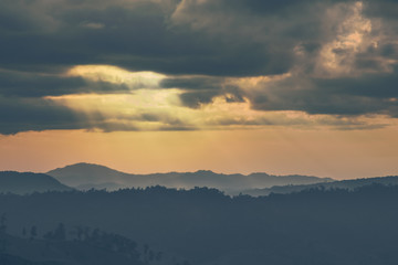 Soft focus winter sunset high up in the silhouette mountains