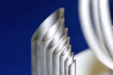 Metal tubes of different diameter on a blue background