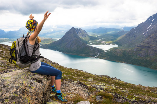 Young Woman Hiking On Besseggen. Happy Girl Enjoy Beautiful Lake And Good Weather In Norway.