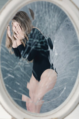 Mirror reflection of anorexic girl