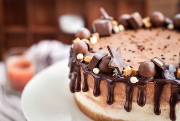 Two-ply chocolate cheesecake decorated with candies and frosting