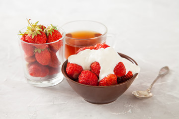 strawberry with sour cream in a bowl on a table, selective focus