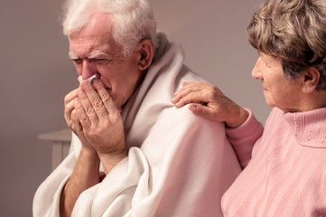 Senior woman and ill man with a cold