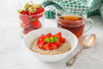 porridge with strawberry on a table, selective focus