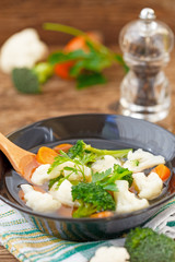 Mixed cooked vegetables in a bowl, vertical. Healthy diet.