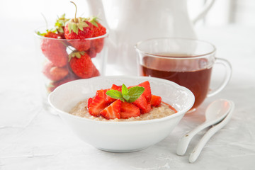 porridge with strawberry on a table, selective focus